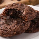 A close up of Easy Brownie Mix Cookies with a bite out of one of them.