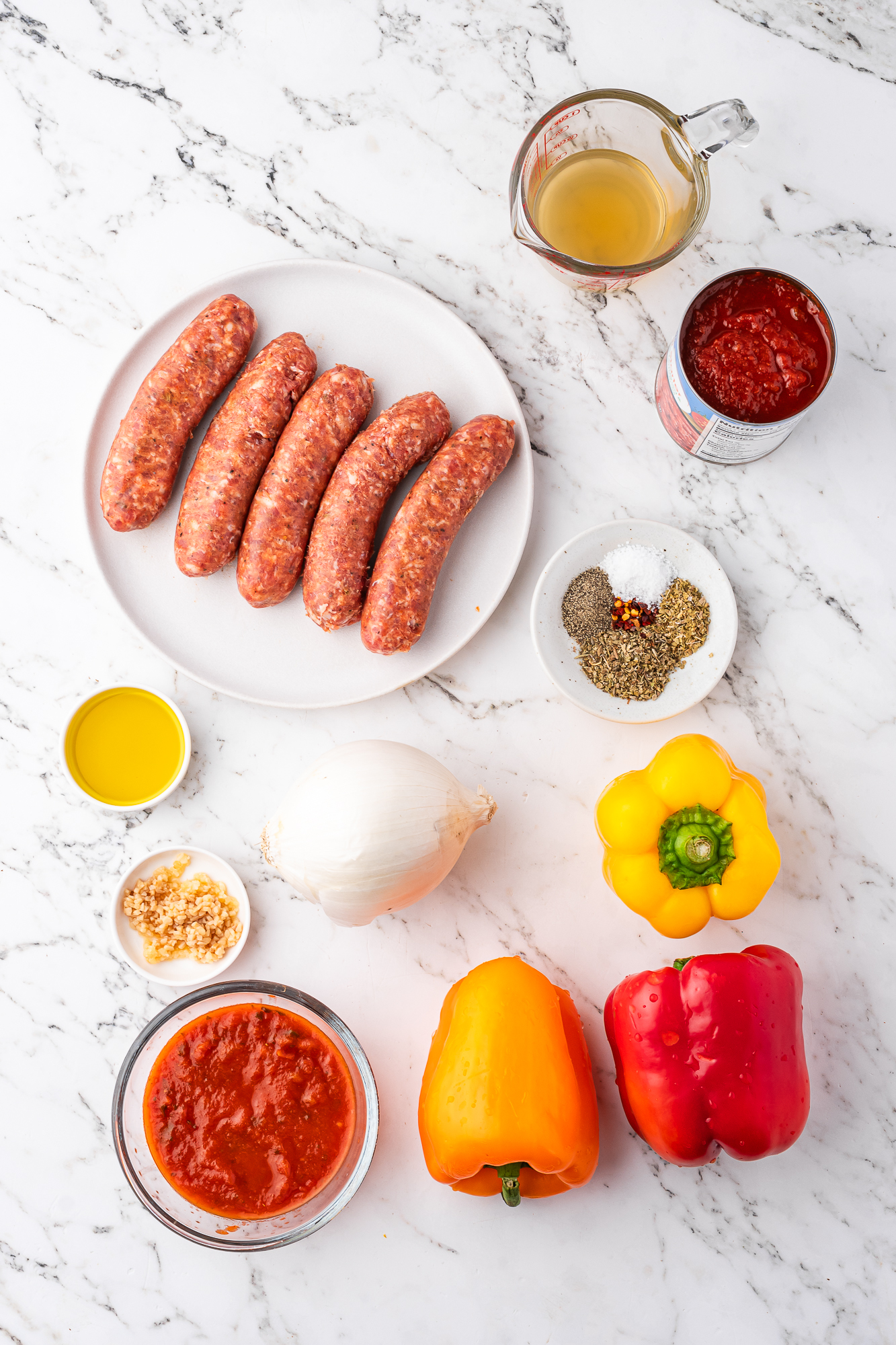 A mis-en-place of ingredients for Slow Cooker Sausage and Peppers