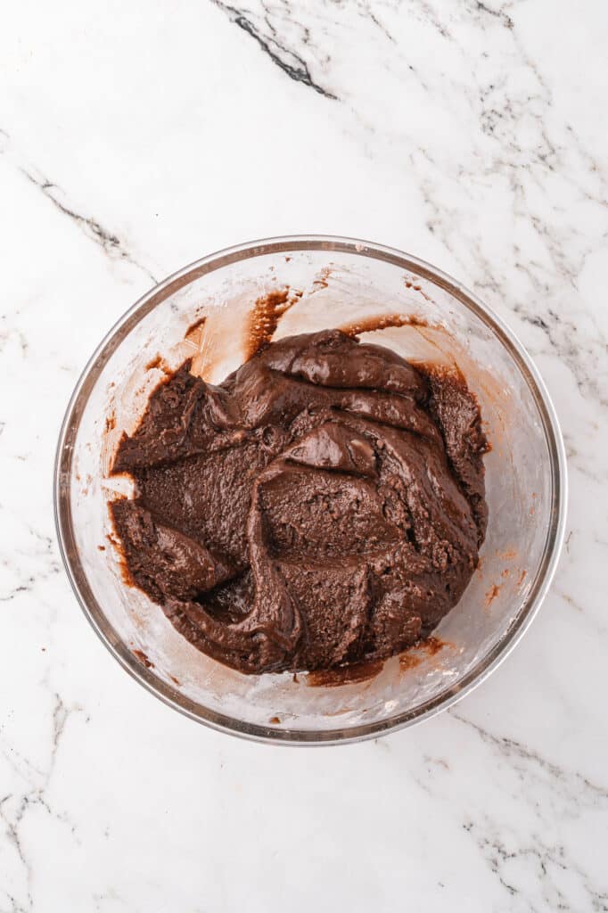 A glass bowl full of mixed batter for Easy Brownie Mix Cookies