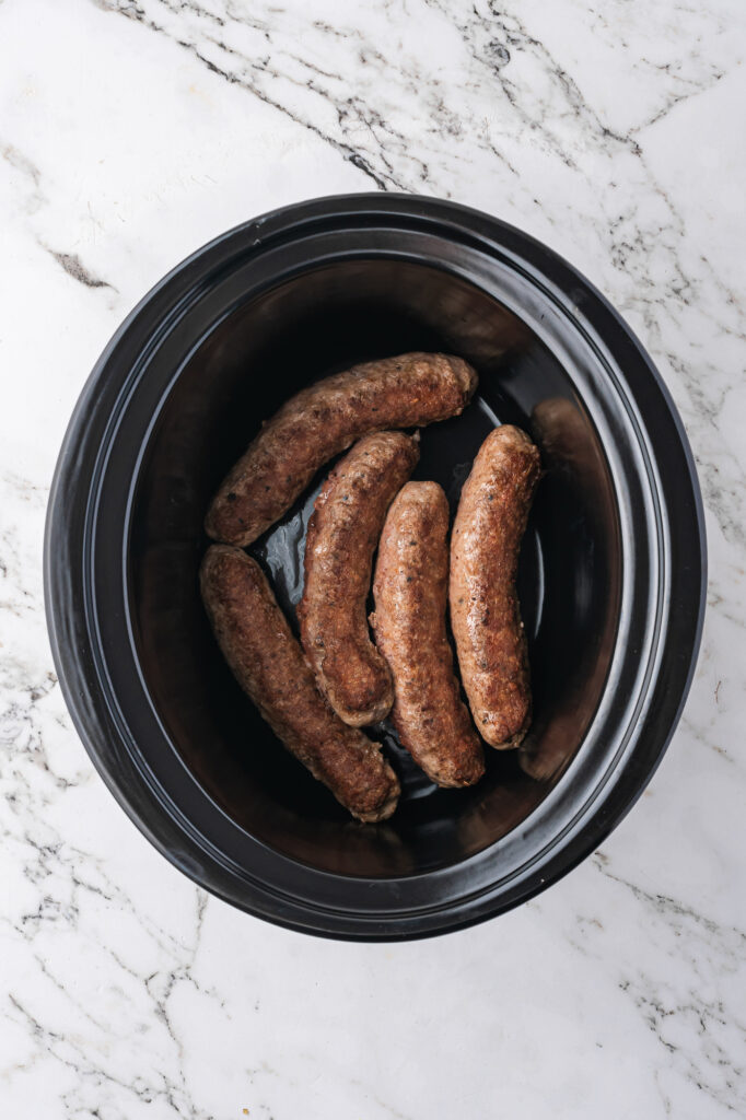 Sausages at the base of a slow cooker