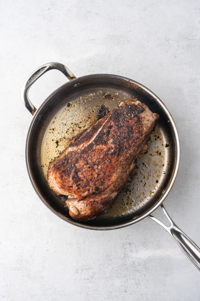 A pan of browning pork butt