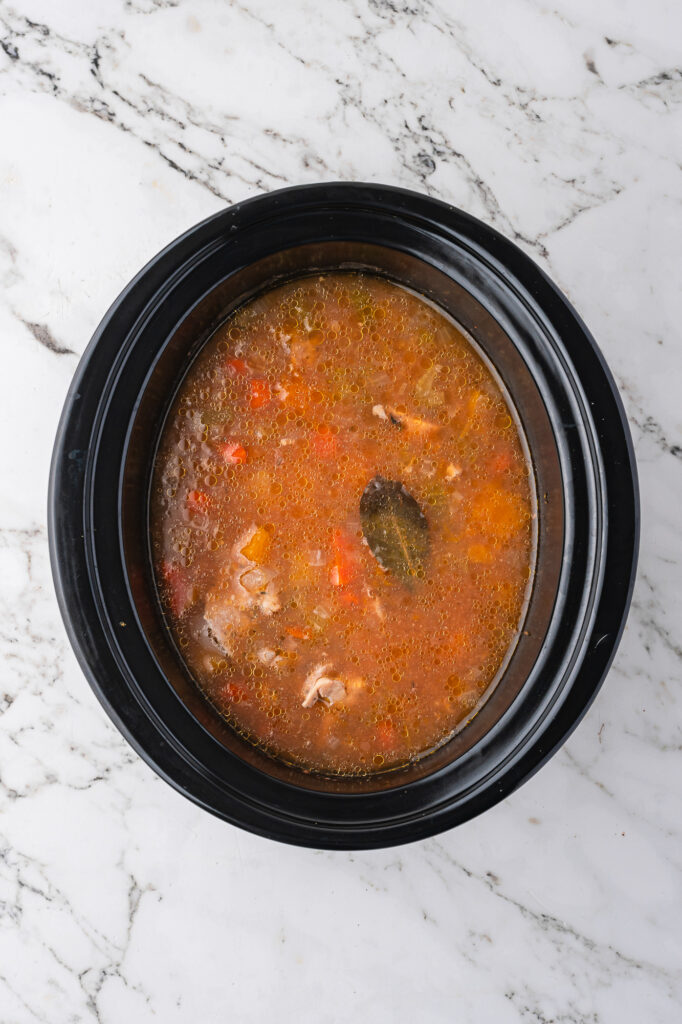 Uncovered Slow Cooker Hearty Chicken Stew cooking in the slow cooker