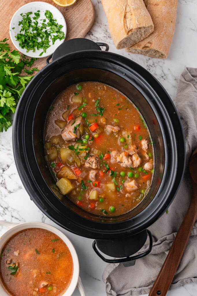 A finished slow cooker full of Slow Cooker Hearty Chicken Stew