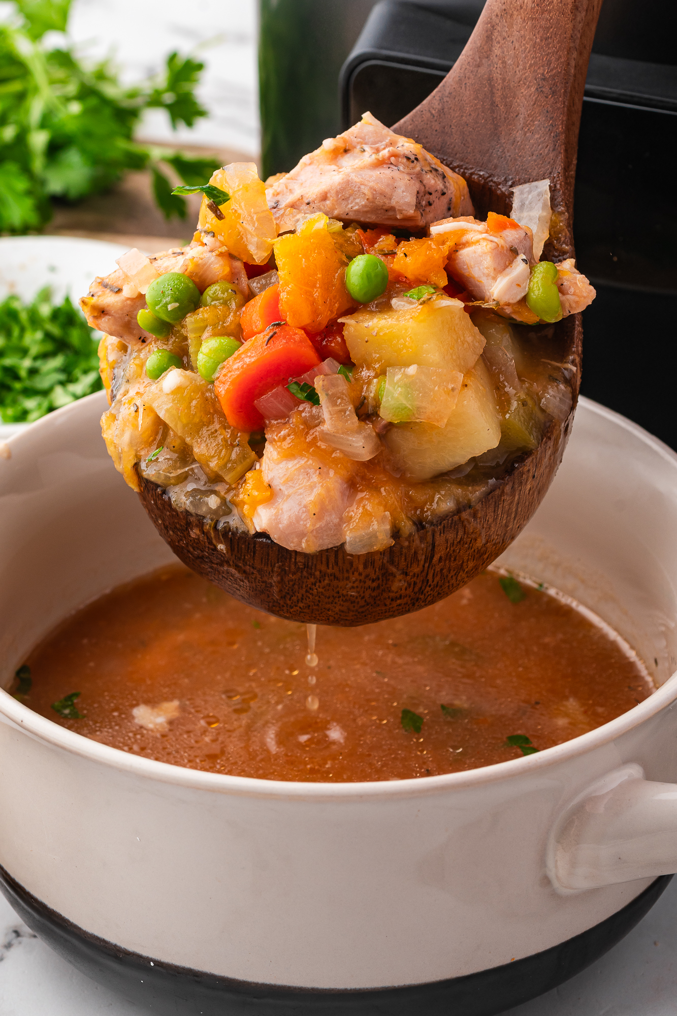 A ladle of Slow Cooker Hearty Chicken Stew