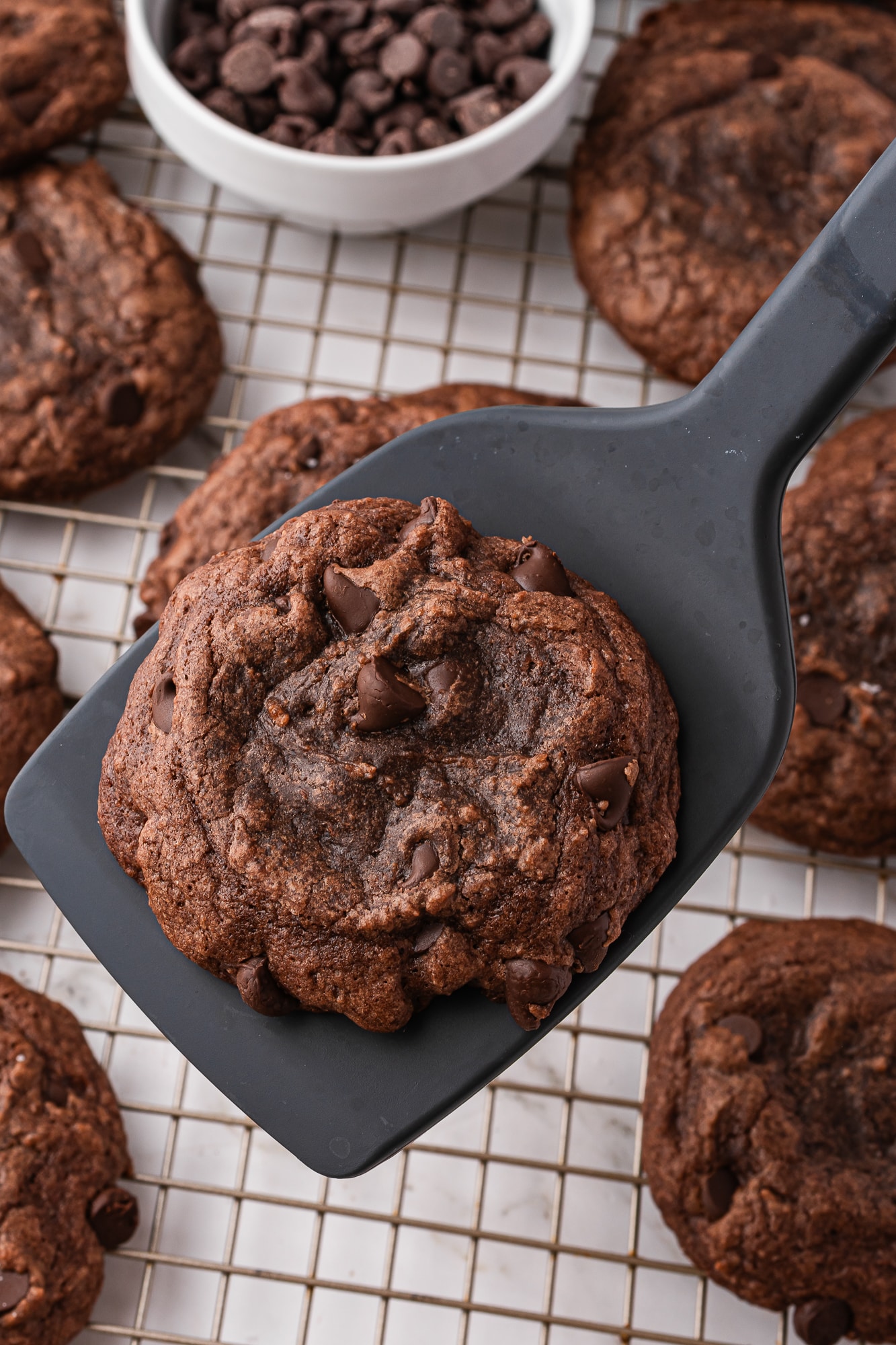 A close up of a black spatula holding a Easy Brownie Mix Cookie