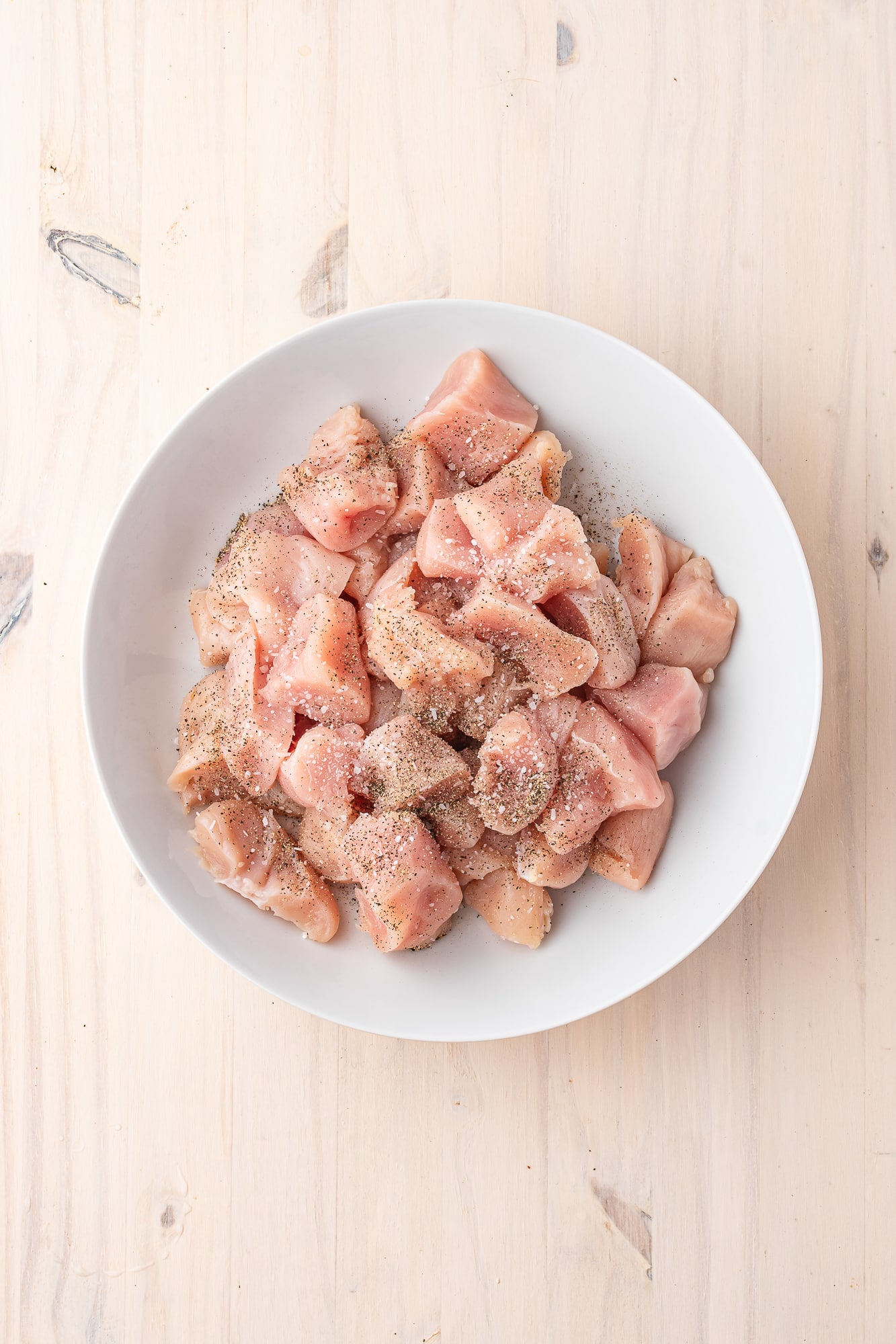 A bowl of seasons raw chicken