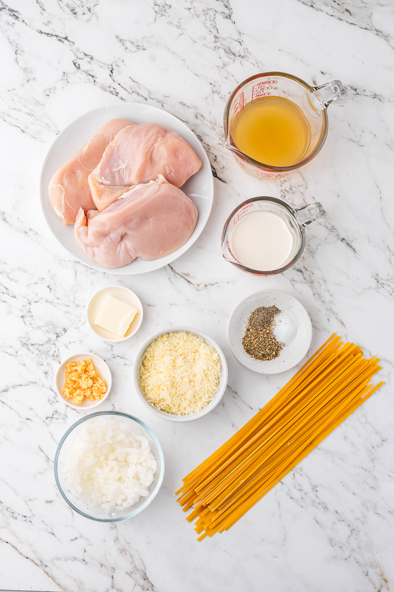 A mis-en-place of ingredients for Slow Cooker Chicken Alfredo