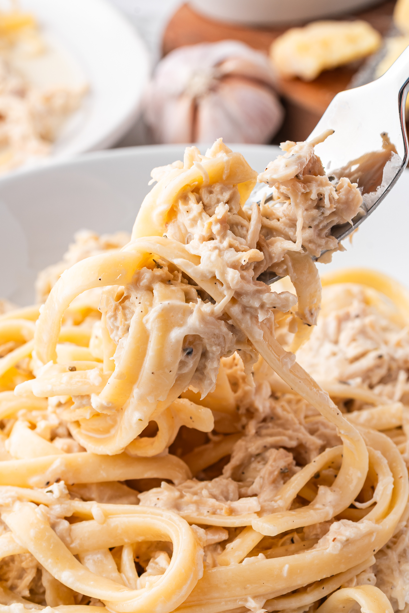 A close up of a fork of Slow Cooker Chicken Alfredo