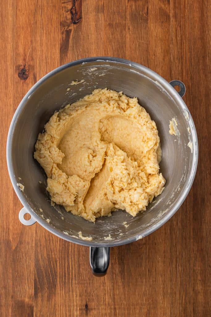 A mixing bowl full of creamed butter and sugar.