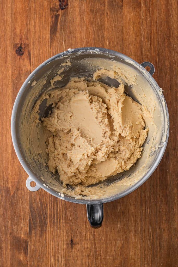 A mixing bowl full of the mixed cookie dough for Halloween Spritz Cookies.