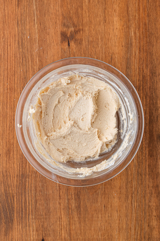 A small glass bowl filled with white cookie dough.